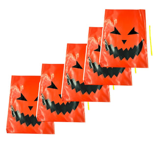 Set of Halloween-themed orange bags with jack-o'-lantern faces on a white background
