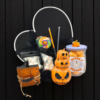 Halloween-themed items including a jack-o'-lantern, candy, and a jar on a black background