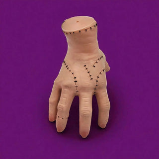 Model of a hand with(acupuncture points) on a purple background