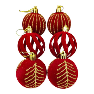 Set of red and gold Christmas ornaments on a white background
