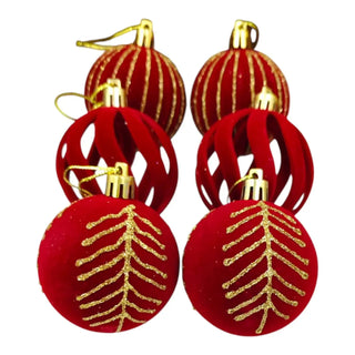 Set of red and gold Christmas ornaments on a white background