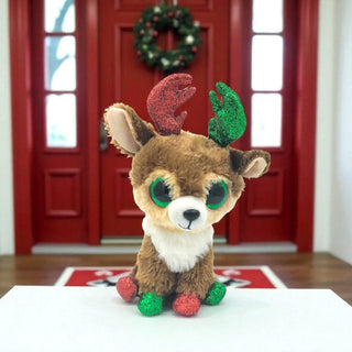 Plush reindeer toy with red and green antlers in front of a red door with a wreath.
