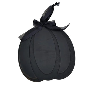 Black decorative item with a bow on a white background