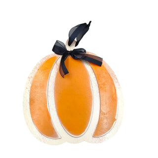Decorative pumpkin with a black bow on a white background