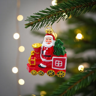 Christmas ornament featuring Santa Claus on a train with a green tree, on a white background. Classic Aesthetic for Christmas