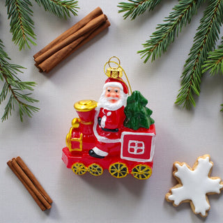 Christmas ornament featuring Santa Claus on a train with a green tree, on a white background. Classic Aesthetic for Christmas