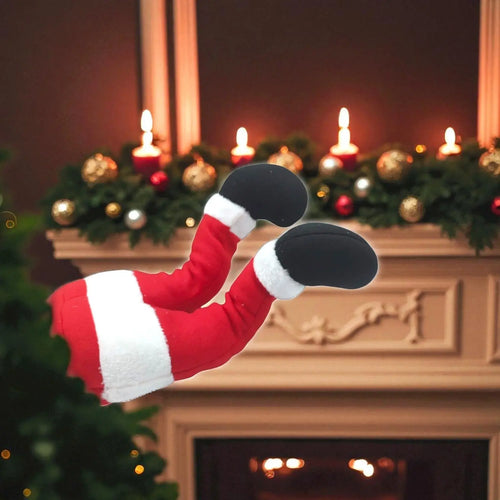 Santa Claus legs in a red suit with white trim against a festive background with candles and greenery.