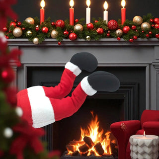 Santa Claus stockings hanging by a fireplace with Christmas decorations.
