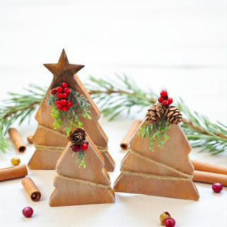 Wooden Christmas tree decorations with pine cones and berries on a white background