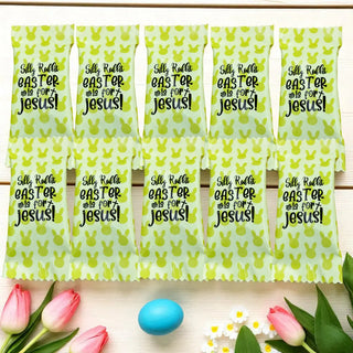 Silky Raffia Easter bags with bunny pattern and text on a wooden surface with flowers.