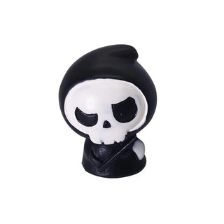 Skull-shaped object with a black hood on a white background