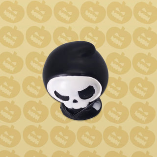 Black and white skull-shaped object on a patterned background