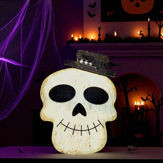 Halloween-themed decoration with a skull-shaped light and checkered hat on a dark background.