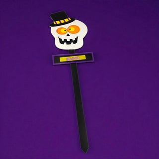 Halloween-themed skull decoration with a top hat and sign on a purple background
