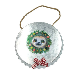 Decorative metal ornament with a sloth wearing a Christmas wreath on a white background