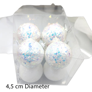 Set of four white Christmas ornaments with blue and purple glitter in a clear packaging on a white background.
