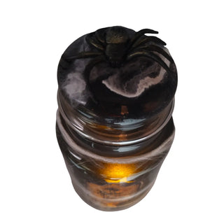 Glass jar with a black lid on a white background