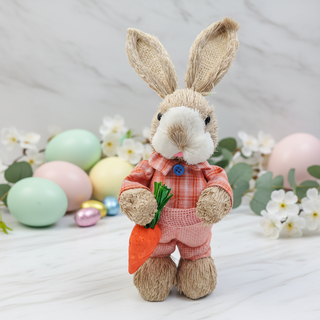 Stuffed bunny toy in a pink outfit with Easter eggs and flowers in the background