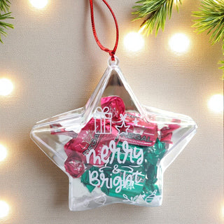 Star-shaped clear ornament with candy and 'Merry & Bright' text, hanging against a festive background.