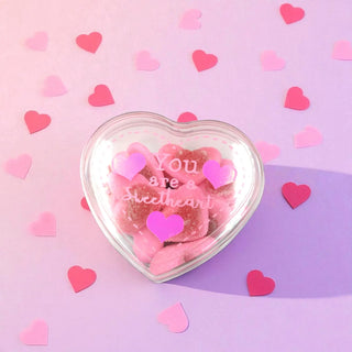 Heart-shaped container with pink candies and 'You are a sweetheart' text on a pink and purple gradient background with heart confetti.