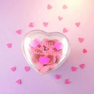 Heart-shaped container with pink candies and 'You are a sweetheart' text on a pink background with heart decorations.