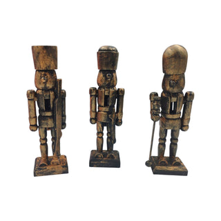 Three wooden nutcracker figurines on a white background