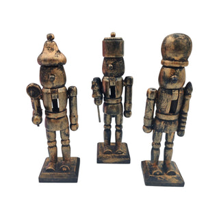 Three wooden nutcracker figurines on a white background