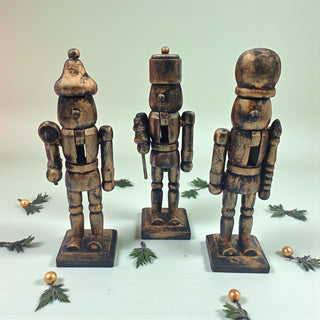 Three wooden nutcrackers on a light background with decorative elements.