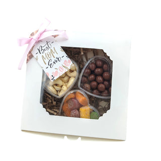 Assorted candies in a box with a 'Best Cow Ever' tag on a white background