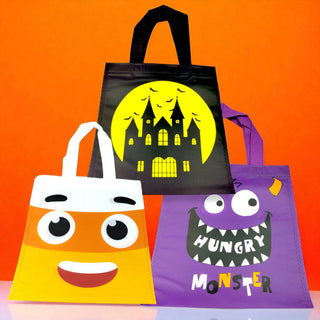 Three Halloween-themed tote bags on an orange background