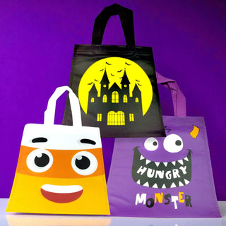 Three Halloween-themed tote bags on a purple background