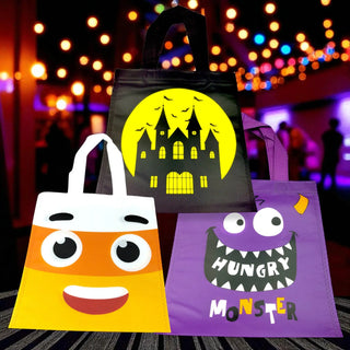Three Halloween-themed bags with colorful designs against a blurred festive background.