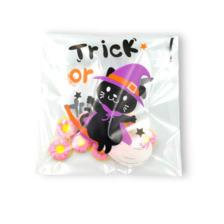 Halloween-themed black cat with a purple witch hat in a clear package with text