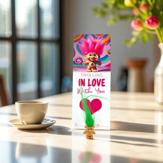 Troll doll figure with a box labeled 'Trolling in Love with You' on a table.