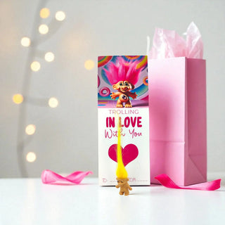 Troll doll gift set with pink bag and card on a white background