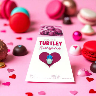 Valentine's Day card with turtle design surrounded by colorful candies on a pink background