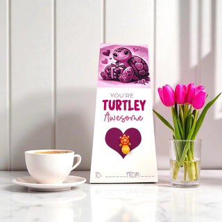 Valentine's Day card with turtle illustration, cup of coffee, and tulips on a table.