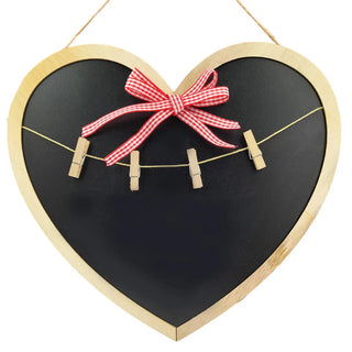 Heart-shaped blackboard with wooden frame, clothespins, and a red checkered bow on a white background