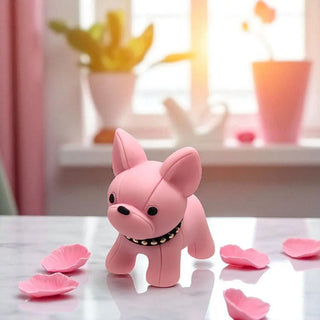 Pink dog-shaped toy on a surface with pink petals and a blurred background