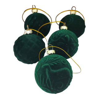 Set of green velvet Christmas ornaments on a white background