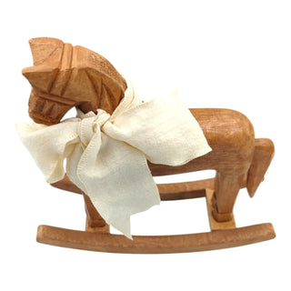 Wooden rocking horse with a bow on a white background
