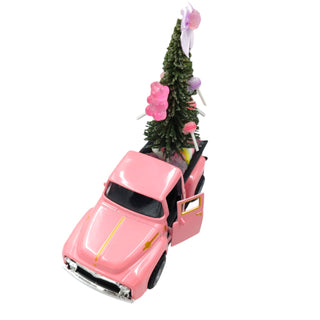 Pink toy truck with a Christmas tree and decorations on a white background