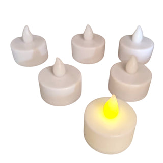 Set of six white LED candles with one glowing on a white background