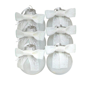 Decorative Christmas ornaments with white ribbons on a white background