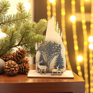 Decorative wooden piece with deer and trees on a table with Christmas decorations. Woodlands, Nordic Aesthetic