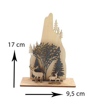 Wooden decorative piece with cut-out trees, deer, and mountains on a white background. Woodlands Nordic Aesthetic