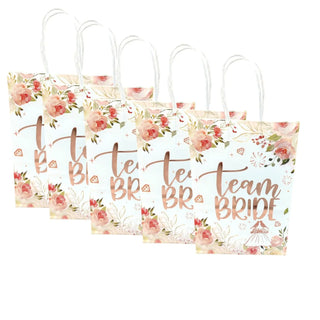 Three gift bags with floral designs and 'Team Bride' text on a white background