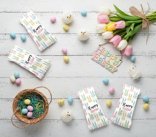 Easter-themed cards with eggs, tulips, and bunnies on a wooden surface.