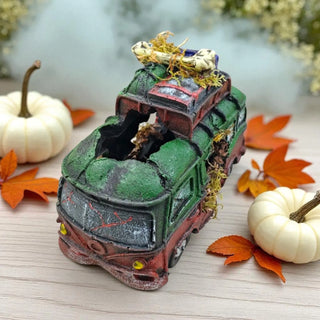 Decorative bus with pumpkins and leaves on a wooden surface