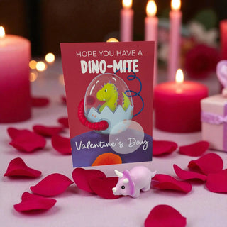 Valentine's Day card with dinosaur design surrounded by candles and rose petals